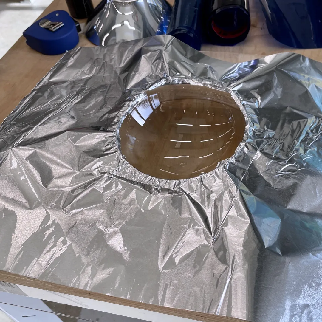 Aluminium foil around a transparent dog bowl.